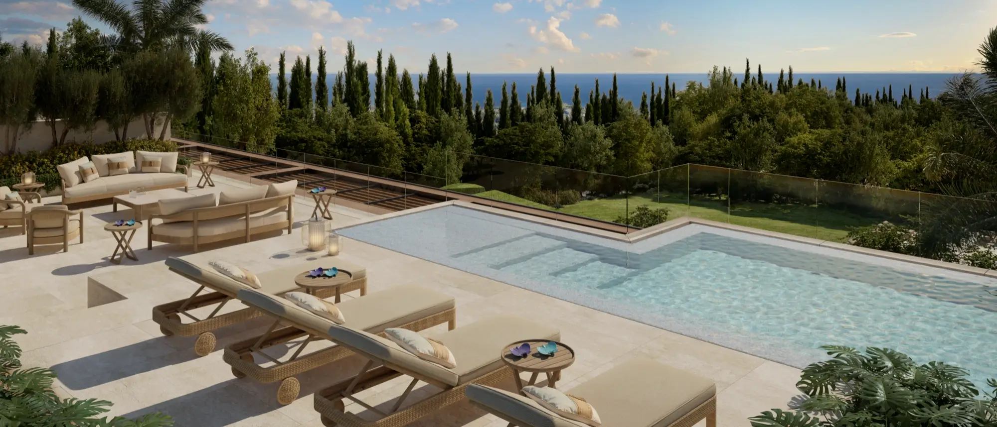 Sleek glass-fronted infinity pool and outdoor terrace area looking out over lush treetops to the sea at Armani Residences Marbella