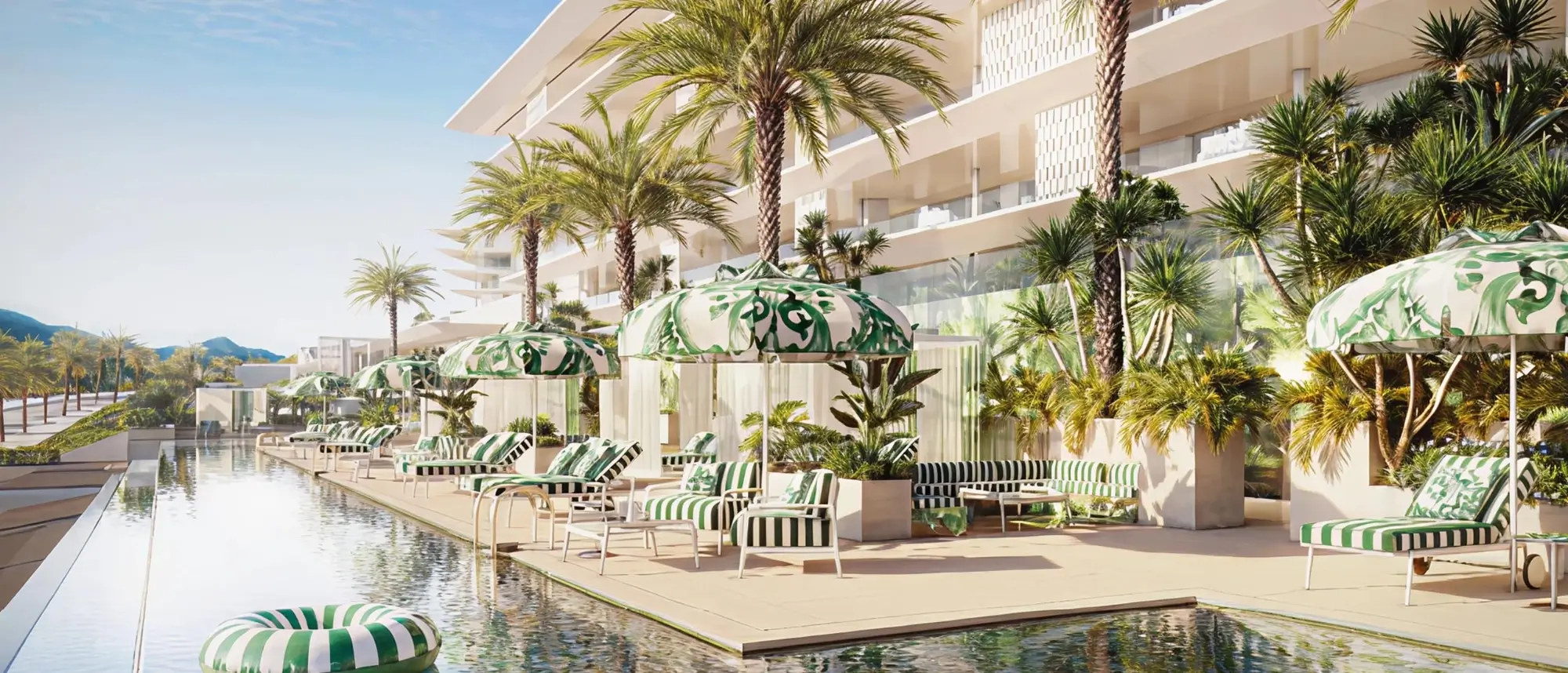 Opulent poolside deck at Design Hills by Dolce and Gabbana Marbella showing signature patterned sun loungers and manicured palms